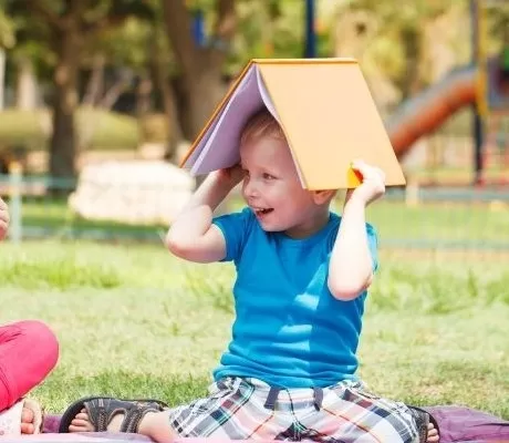 Kids having fun with books outside